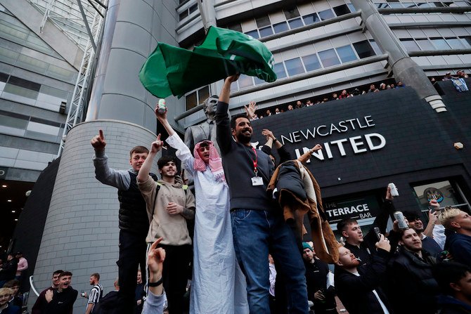 Fans celebrate outside St. James’ Park. after the Newcastle United takeover was announced. (Reuters)