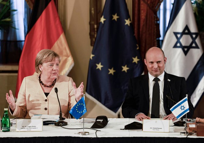 German Chancellor Angela Merkel attends a cabinet meeting with Israeli Prime Minister Naftali Benett in Jerusalem on Oct. 10, 2021. (Pool photo via AFP)