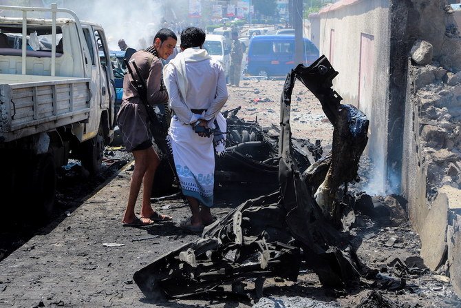 Policemen and firefighters work at the scene of a blast in Aden. (Reuters)