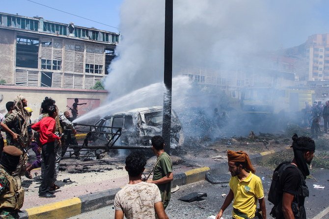 Policemen and firefighters work at the scene of a blast in Aden. (Reuters)