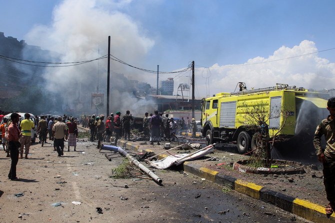 Policemen and firefighters work at the scene of a blast in Aden. (Reuters)