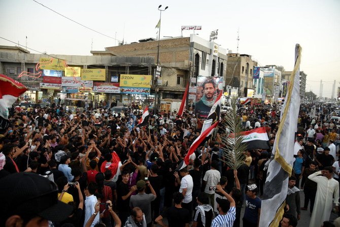 People supporting the Imtidad Movement celebrate after preliminary results of Iraq's parliamentary election were announced in Al-Haboubi square in Nassiriya, Iraq October 11, 2021. (Reuters)