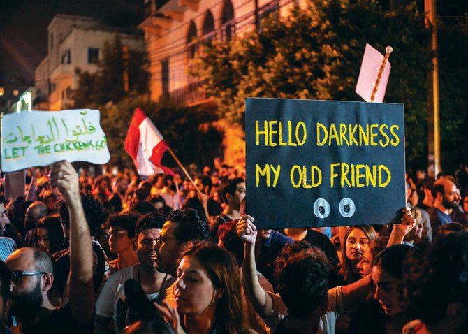 Protesters gather in front of the Lebanese electricity company headquarters in Beirut, where a crippling cocktail of crises is threatening to plunge the cash-strapped country into total darkness. (AP)