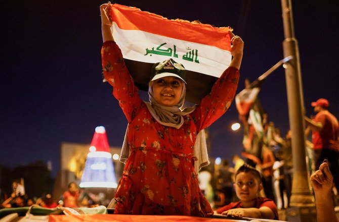 Supporters of populist Shiite cleric Muqtada Al-Sadr’s movement celebrate after preliminary results of Iraq’s parliamentary election were announced on Oct. 11, 2021. (Reuters)