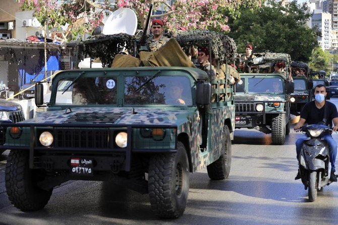 Lebanese army soldiers patrol near the Justice Palace as supporters of the Shiite Hezbollah and Amal groups protest against Judge Tarek Bitar who is investigating last year's deadly seaport blast, in Beirut, Lebanon, Thursday, Oct. 14, 2021. (AP)