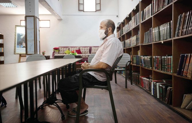 Saleh, a prisoner who has been languishing in Moroccan jails for 19 years on terrorism charges, sits at the library inside Kenitra Prison, in the coastal city of the same name, near the Moroccan capital Rabat. (AFP)