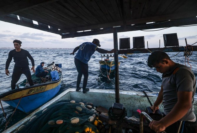 Palestinian fishermen complain they must seek a catch from overfished shallow waters with declining stocks. (AFP)
