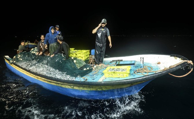 Palestinian fishermen return to the coastline of Gaza City to unload their catch. (AFP)