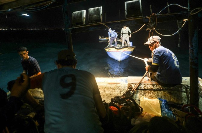 Palestinian fishermen stay close to shore due to Israeli restrictions on powerful engines. (AFP)