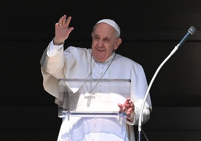 Pope Francis waves to faithfuls from the window of the apostolic palace overlooking St. Peter's Square, as he arrives to hold his weekly Angelus prayer in The Vatican. (AFP)