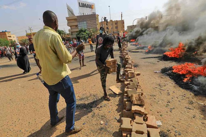 Sudanese protesters put up road blocks in Khartoum amid reports of a military coup. (AFP)