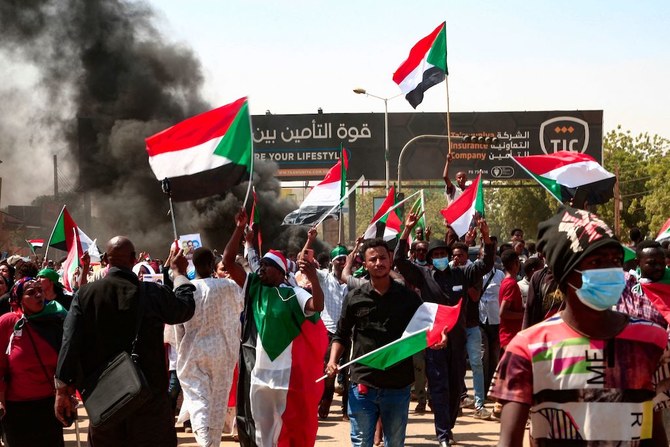 Sudanese demonstrators take to the streets of Omdurman, the capital Khartoum's twin city, to demand the government's transition to civilian rule, on October 21, 2021. (AFP)