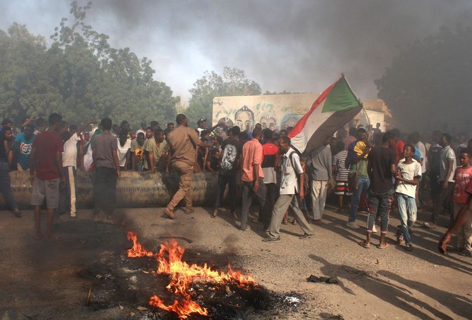 Sudanese man protest against a military coup that overthrew the transition to civilian rule, on October 25, 2021 in the Al-Shajjara district in southern Khartoum. (AFP)