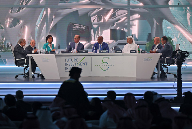 CNN's Richard Quest (L) moderates a session at the annual Future Investment Initiative (FII) conference in the Saudi capital Riyadh on October 26, 2021. (AFP)