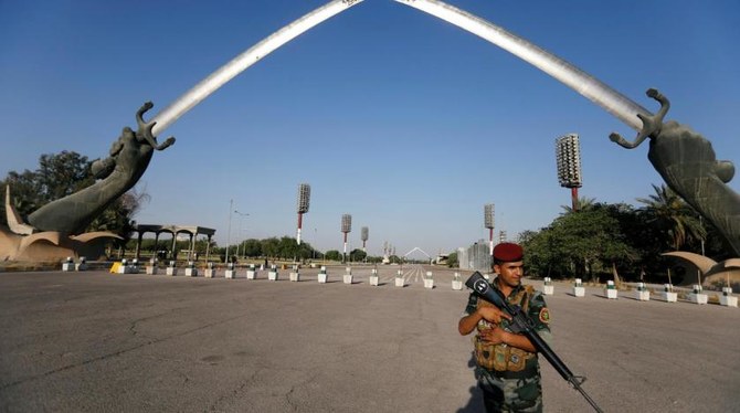 An Iraqi security officer stands guard next to the