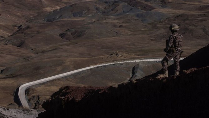 A Turkish special forces police officer stands watch at a border outpost, in front of a section of the new Iran-Turkey border wall, Caldiran, Turkey, Sept. 27, 2021. (Getty Images)