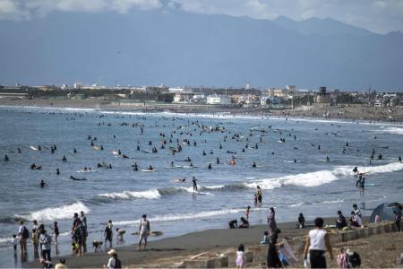 People visit a beach in Fujisawa, Kanagawa prefecture on October 2, 2021. (AFP)