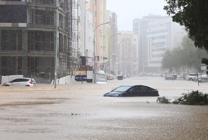 Cars are seen abandoned on a flooded street as Cyclone Shaheen makes landfall in Muscat Oman, October 3, 2021. (Reuters)