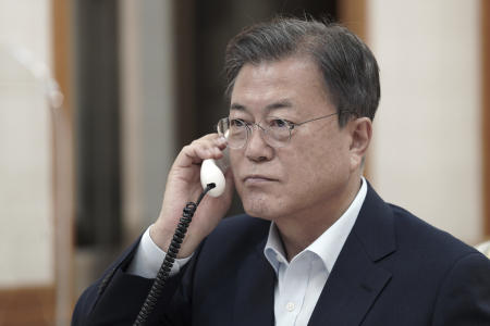 In this photo provided by South Korea Presidential Blue House via Yonhap News Agency, South Korean President Moon Jae-in talks on the phone with Japanese Prime Minister Fumio Kishida at the presidential Blue House in Seoul, South Korea, Friday, Oct.15, 2021.(AP)