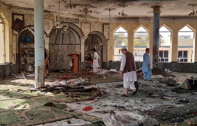 People inspect the inside of a mosque following a bombing in Kunduz province, northern Afghanistan, October 8, 2021. (AP Photo)