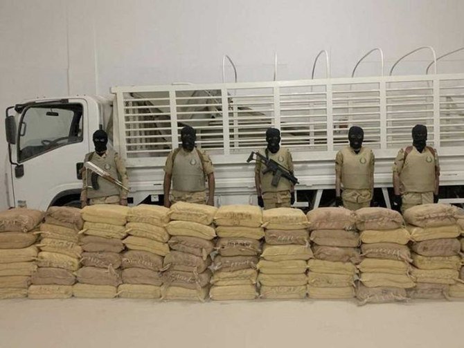 Members of a Saudi anti-narcotics team display a drug haul seized from smugglers linked to Yemen's Iran-backed Houthi terrorists. (SPA file photo)