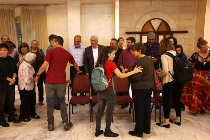 Israeli left wing activists gather with Palestinian activists at the Al-Haq Foundation in Ramallah on Oct. 27, 2021, to denounce Israel’s decision to declare six Palestinian human rights groups as “terror organizations.” (ABBAS MOMANI / AFP)