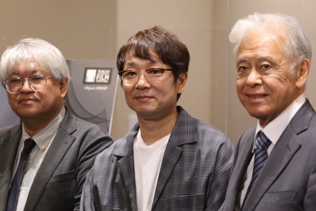 Shozo Ichiyama, Programming director of 34th Tokyo International film Festival (TIFF),  (C) Keisuke Yoshida film maker, and (R) Hiroyasu Ando chairman of 34th TIFF pose to cameras during a press conference held at the Foreign Correspondents’ Club in Tokyo on October 5. ( ANJ/Pierre Boutier)