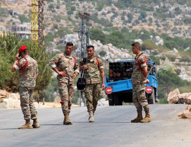 Soldiers stand near a pickup truck replete with a Hezbollah rocket launcher after it was seized by villagers, Chouaya, Lebanon, Aug. 6, 2021. (Reuters)