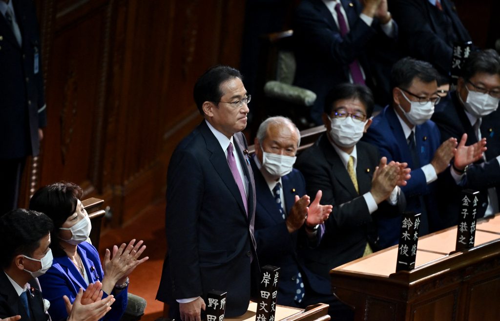 Japan's Prime Minister and leader of ruling Liberal Democratic Party KISHIDA Fumio (3rd-L) is applauded after his position as prime minister was confirmed during a lower house plenary session of parliament, in Tokyo on November 10, 2021. (AFP)