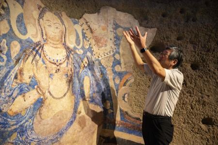 This photo taken on October 7, 2021 shows a replica of a cave painting of a blue Bodhisattva, part of artefacts destroyed by the Taliban in 2001, displayed at the Tokyo University of the Arts in Tokyo. (AFP)