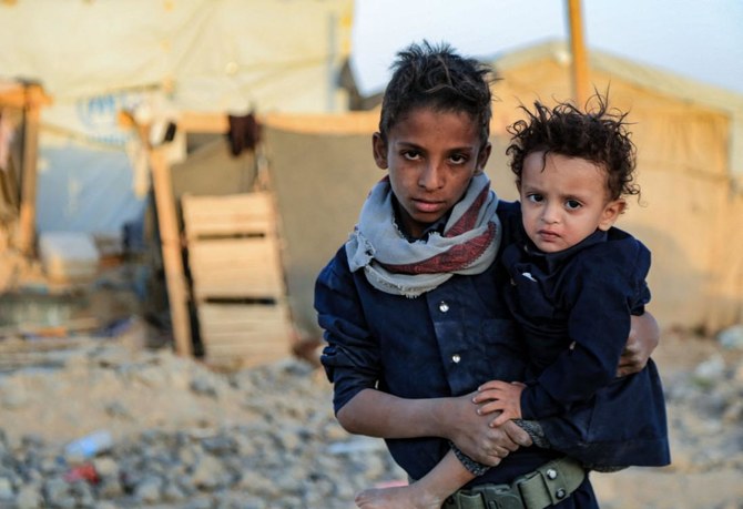 Yemeni children are pictured in front of tents at a camp for internally displaced people on the outskirts of Yemen's northeastern city of Marib, on October 29, 2021. (AFP)