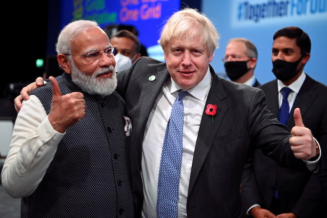 Britain's Prime Minister Boris Johnson and India's Prime Minister Narendra Modi attend the 