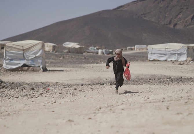 A girl runs at a camp for internally displaced persons (IDPs) in Marib, Yemen, Nov. 3, 2021. (Reuters)