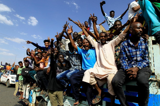 Protesters gesture and shout slogans as they demonstrate against the Sudanese military’s recent seizure of power and ousting of the civilian government, in the capital Khartoum. (Reuters)