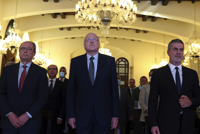 Lebanese Prime Minister Najib Mikati listens to the national anthem during a press conference at the Government House in downtown Beirut, Lebanon, Thursday, Nov. 4, 2021. (AP)