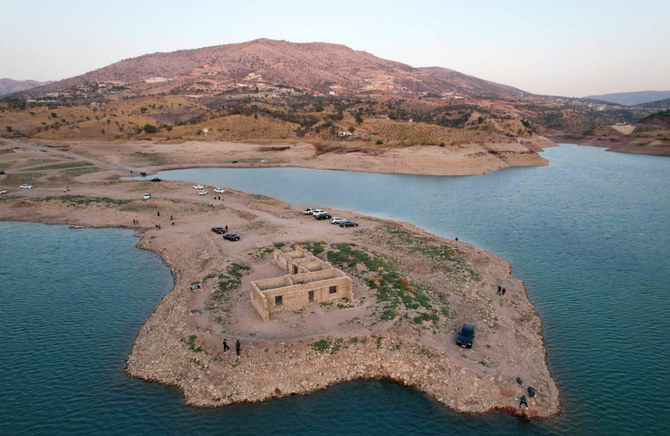 An aerial view shows the remains of the submerged Gary Qasruka village abandoned 36 years ago, which have resurfaced following a large drop in water level of the Dohuk Dam due to drought on November 4, 2021. (AFP)