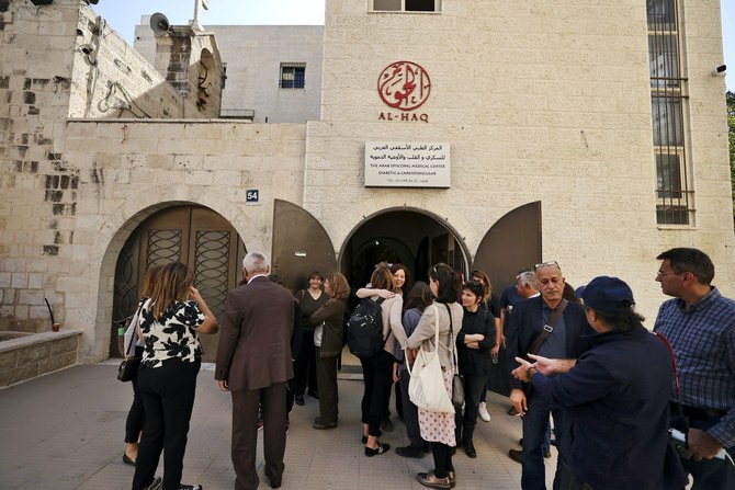 Activists gather at the Al-Haq Foundation in the West Bank city of Ramallah to denounce Israel’s decision to declare six Palestinian human rights groups as ‘terror organizations,’ Oct. 27, 2021. (AFP)