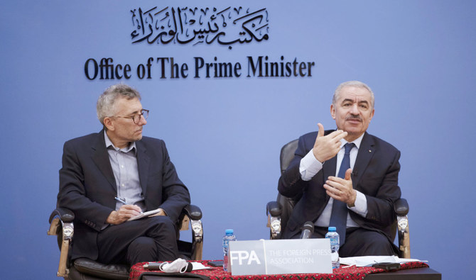 Palestinian Prime Minister Mohammad Shtayyeh, right, holds a briefing with foreign press alongside Andrew Carey, chairman of the Foreign Press Association (FPA), in the West Bank city of Ramallah, Wednesday, Nov. 10, 2021. (AP)