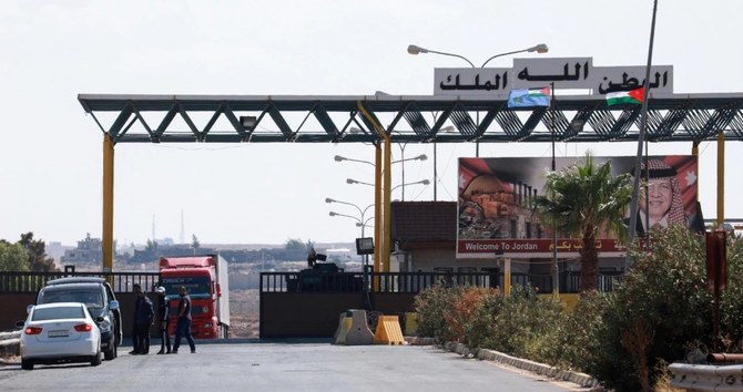 Vehicles enter Syria through the Nassib/Jaber border post with Jordan. (AFP/File)