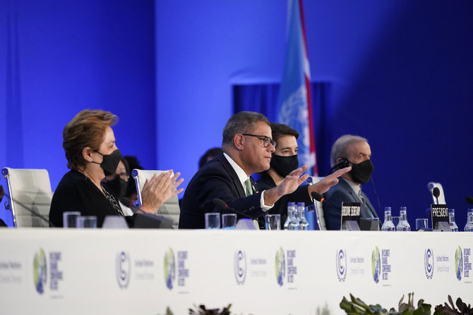 Britain's Alok Sharma gestures as delegates applaud during the closing plenary session at the COP26 UN Climate Summit, in Glasgow, Scotland, Saturday, Nov. 13, 2021. (AP)