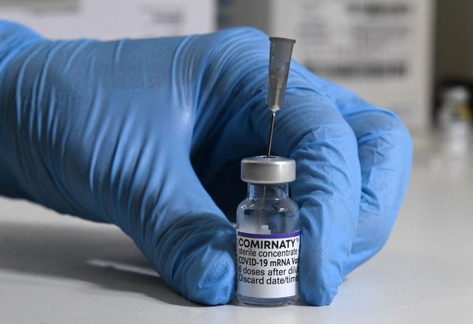 A vial of the COVID-19 vaccine of Pfizer-BioNTech stands at a table in a vaccination center in Haar near Munich, southern Germany, on November 19, 2021. (AFP)