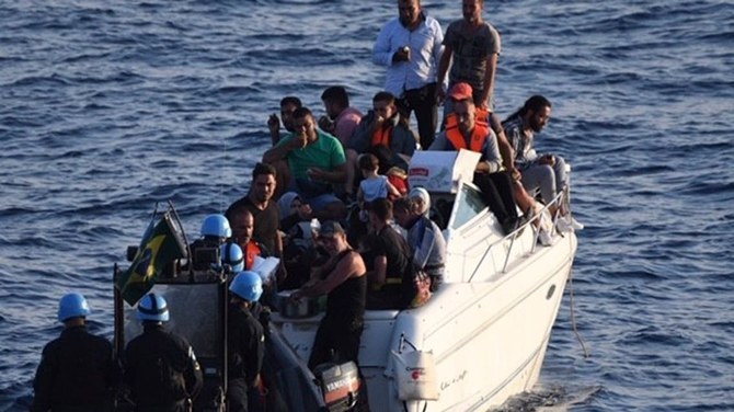 File photo of a UNIFIL navy boat in Lebanon approaching a boat overcrowded with migrants in the Mediterranean Sea in 2018. (AP/File Photo)