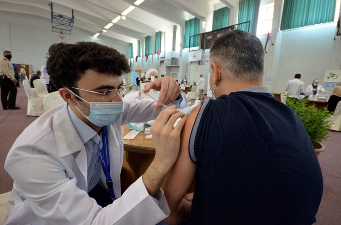 A medical worker administers the coronavirus disease (COVID-19) vaccine to a man in Amman, Jordan. (File/Reuters)