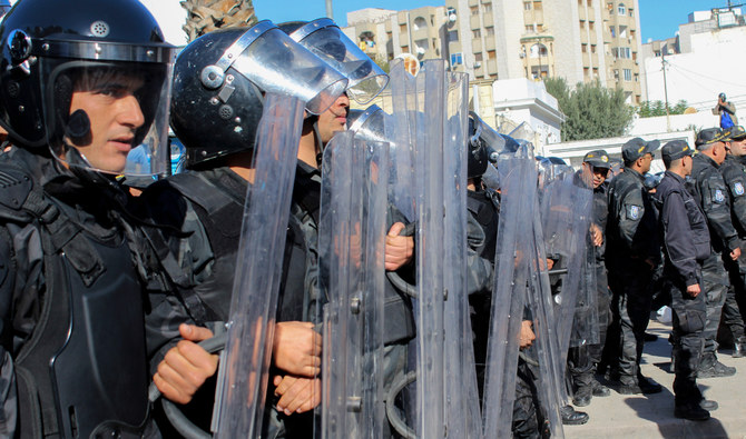 Riot police face demonstrators during a rally in Tunis on Saturday. (AP)