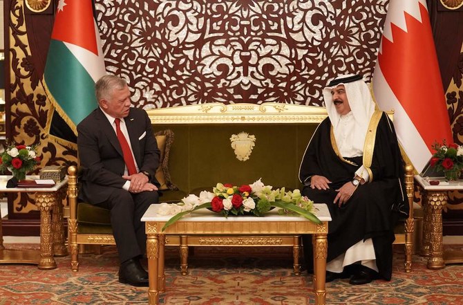 Jordan’s King Abdullah II (L) meets with Bahrain’s King Hamad upon his arrival at the Sakhir Air Base on Nov. 22, 2021. (Jordanian Royal Palace/Yousef Allan/AFP)