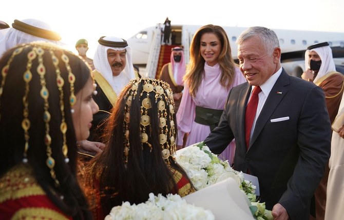 Jordan’s King Abdullah II (R) and his wife Queen Rania are received by Bahrain’s King Hamad upon their arrival at the Sakhir Air Base on Nov. 22, 2021. (Jordanian Royal Palace/Yousef Allan/AFP)