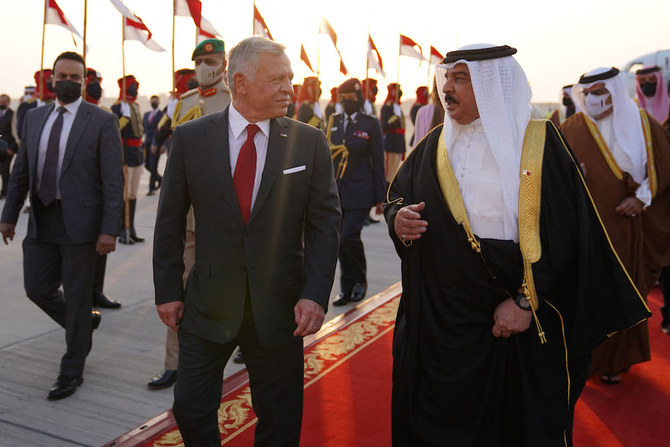 Jordan’s King Abdullah II (L) is received by Bahrain’s King Hamad upon his arrival at the Sakhir Air Base on Nov. 22, 2021. (Jordanian Royal Palace/Yousef Allan/AFP)