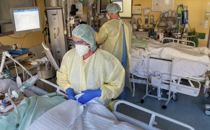 Intensive care nurses treat patients severely ill with Covid-19 disease in the Corona intensive care unit at the University Hospital in Halle/Saale on Monday, Nov. 22, 2021. (AP
