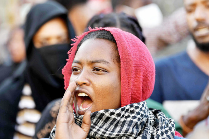 A Sudanese anti-coup protester chants slogans during a demonstration in the 