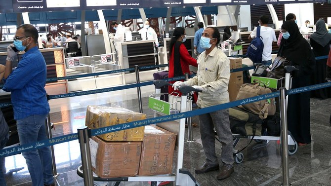 Indian nationals check in at the Muscat International Airport before leaving the Omani capital. (File photo: AFP)